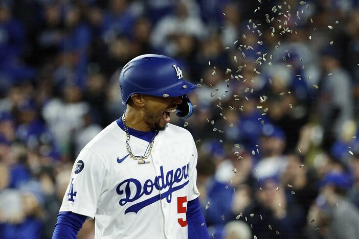 Los Angeles Dodgers' Mookie Betts is showered with sunflower seeds after hitting a two-run home run against the Atlanta Braves during the sixth inning of a baseball game Tuesday in Los Angeles.