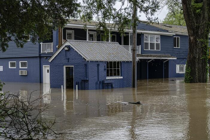 A flooded home is seen from the banks of the Ohio River on Saturday in Louisville, Ky.