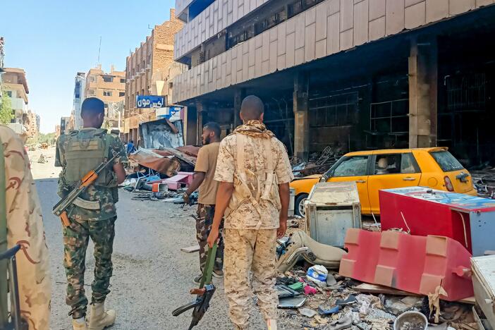 Army soldiers patrol a market area in Khartoum.