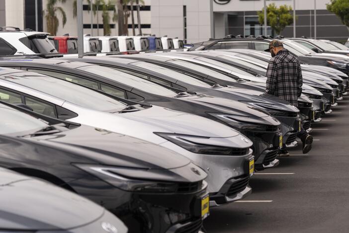 A person looks at a new vehicle at a Toyota dealership in El Monte, Calif., Thursday, March 27, 2025. (AP Photo/Jae C. Hong)