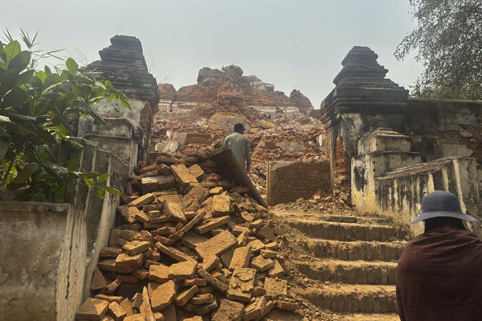 Visitors walk near damaged Maha Aungmye Bonzan Monastery, commonly known as the Me Nu Brick Monastery, in the aftermath of Friday's earthquake in Innwa, Tada-U township, Mandalay, Myanmar on Friday.