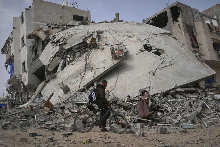 A man passes by the destroyed house of journalist Islam Meqdad, where she was killed along with her son and five other family members in an Israeli army strike in Khan Younis, southern Gaza Strip, Sunday, April 6, 2025.