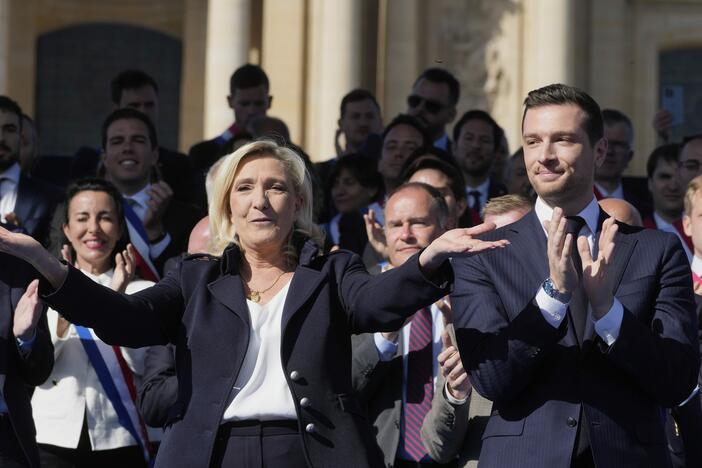 French far-right leader Marine Le Pen, left, reacts with Jordan Bardella during the French far-right party national rally near the parliament in Paris on Sunday.