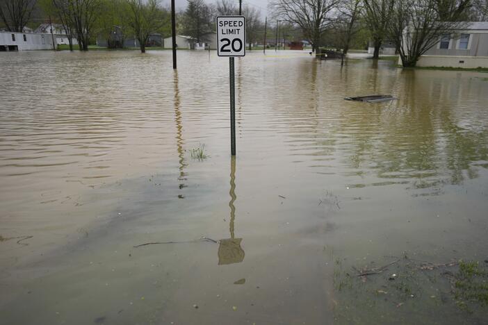 Residential streets are flooded by the rising Licking River, Sunday, April 6, 2025, in Falmouth, Ky. (AP Photo/Carolyn Kaster)