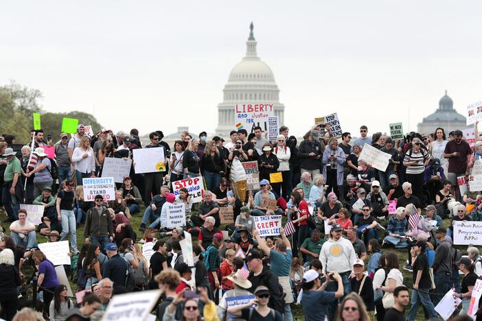 Protesters attend a "Hands Off" rally Saturday to demonstrate against President Trump on the National Mall in Washington, D.C.