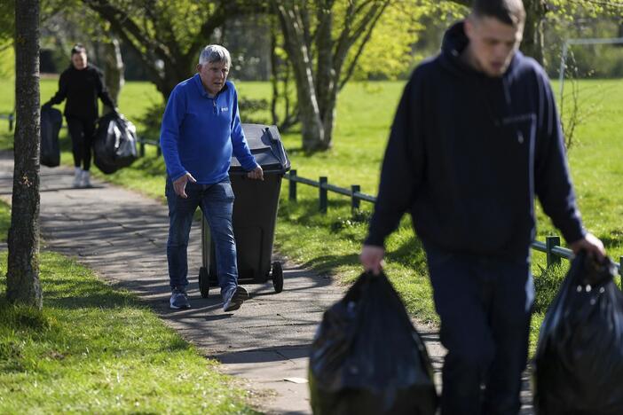 Local residents deliver rubbish to mobile collection vehicles in Erdington, Birmingham, England on Monday.