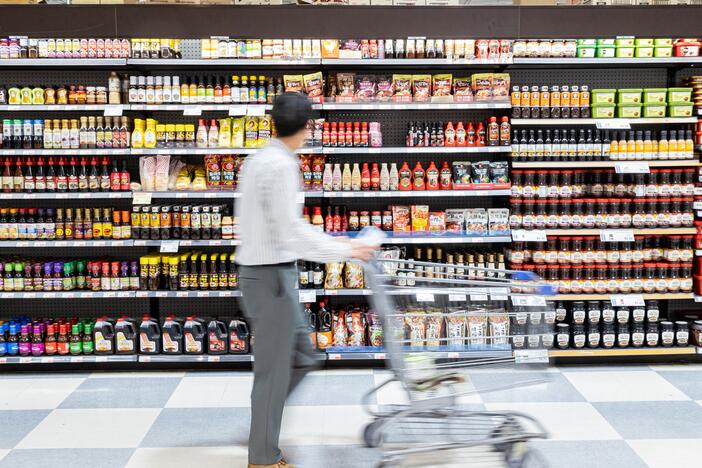 A shopper is walking past a shelf filled with soy sauce and gochujang at Lotte Plaza Market in Centreville, Va., on Friday. Many of the store's products are imported from Asian countries that have been hit with tariffs, which will likely cause prices to rise for consumers.