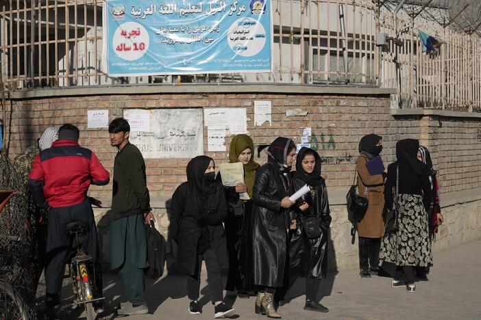 Women students stand outside Kabul University in Afghanistan. As of December 2022, the Taliban has banned women from higher education. But for some, a USAID grant provided online options as well as a chance to study abroad. That scholarship program has now been terminated.
