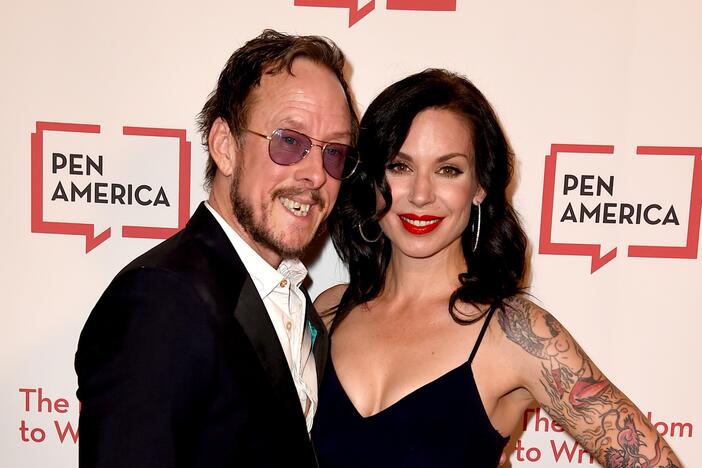 When police came to the cul de sac road in Los Angeles where Jillian Lauren lives with her husband, Weezer bassist Scott Shriner, they were pursuing a suspect in a hit-and-run. But Lauren was shot after police say she pointed a gun at them. The couple are seen here in 2018.