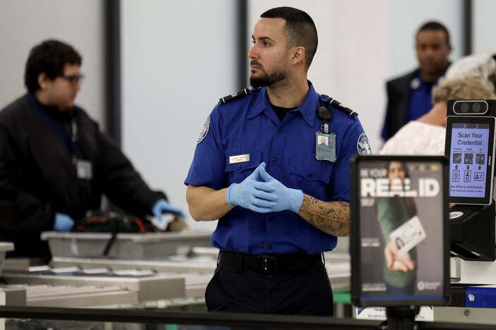 A Transportation Security Administration agent stands at a security checkpoint at Miami International Airport on Dec. 20, 2024. The federal government is preparing to begin implementing Real ID rules in May.
