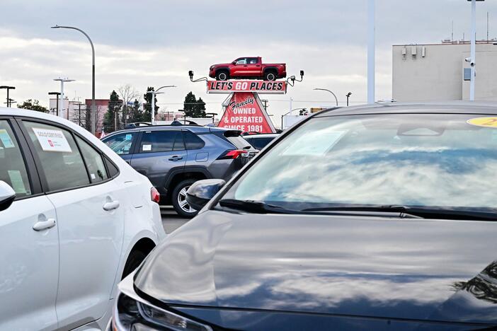 A pickup truck is raised for display at a car dealership in Alhambra, California, on March 27, 2025. After President Trump announced significant tariffs on imported vehicles and parts, automaker stocks fell sharply. But sales at dealerships rose, at least in the short-term, as buyers try to get ahead of the anticipated price spikes in the coming months.