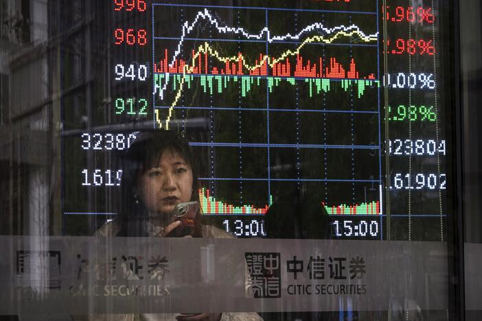A stock ticker shows trading at a securities firm in Beijing April 9.