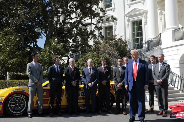 President Trump talks to reporters about his tariff decision during an event with race car drivers and owners at the White House on April 9.