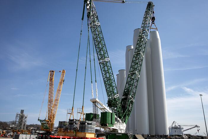 A crane stacks turbine components at the New London State Pier Terminal. The offshore wind industry has generated millions of dollars for the city and local economy in recent years.