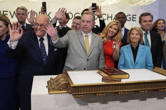 Newsmax CEO Christopher Ruddy, center, and former New York Mayor Rudy Giuliani, center left, celebrate the conservative network's initial public offering on the floor of the New York Stock Exchange on April 3.