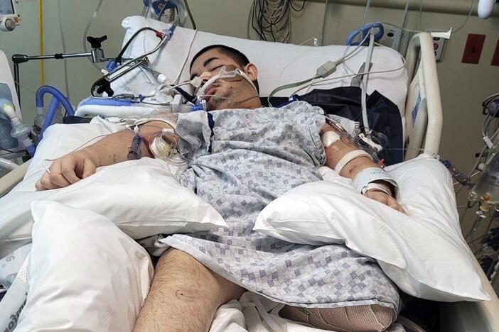 This photo provided by Ana L Vazquez, shows Victor Perez in a hospital bed in Pocatello, Idaho.