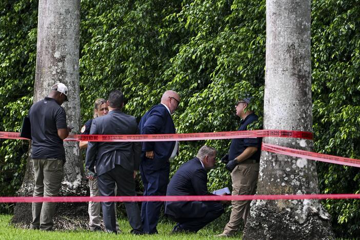 Law enforcement officials work at the crime scene outside the Trump International Golf Club in West Palm Beach, Fla., on September 16, 2024, following the attempted assassination on then-Republican presidential candidate Donald Trump. Ryan Routh is charged in the case and appeared at a federal court hearing on Tuesday in Fort Pierce, Fla.