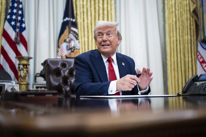 President Trump speaks to reporters and signs an executive order in the Oval Office on March 31.