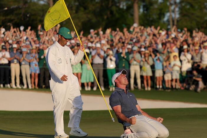Rory McIlroy of Northern Ireland (R) celebrates winning with caddie Harry Diamond (L) after the playoff hole during the final round of the 2025 Masters Tournament at Augusta National Golf Club on April 13 in Augusta, Ga.