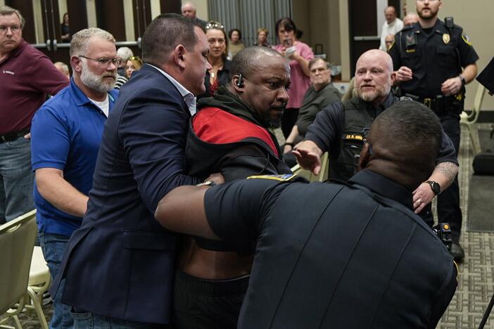 Police forcibly removed several protesters from Rep. Marjorie Taylor Greene's Tuesday town hall in Acworth, Ga.