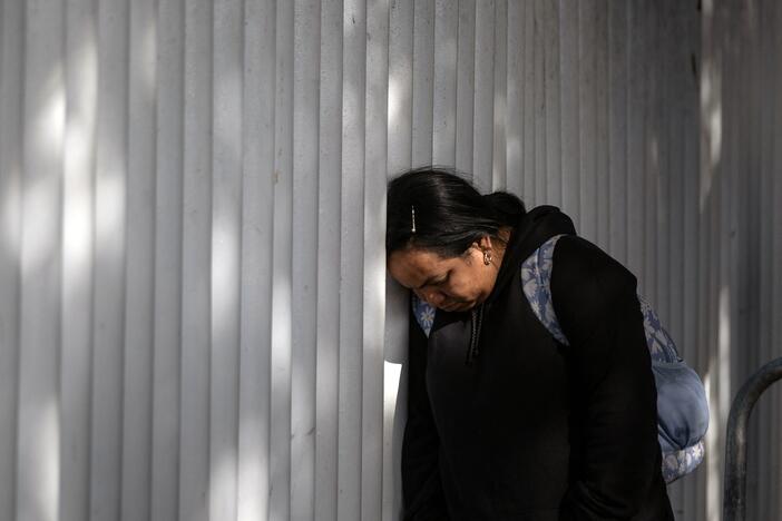 An asylum seeker reacts while waiting for news on her appointment with U.S. authorities before crossing through El Chaparral port in Tijuana, Baja California state, Mexico, on Jan. 20, 2025.