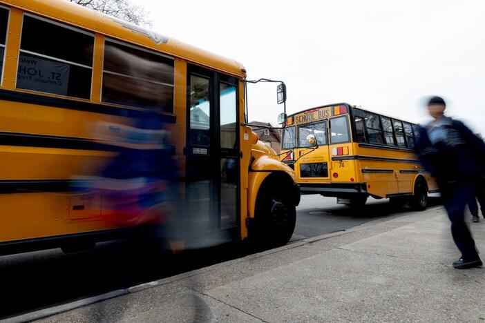 Students walk to their buses at the end of the school day in Minneapolis, Minn. Minnesota, Illinois and Wisconsin are among the states pushing back on the U.S. Education Department's DEI directive.