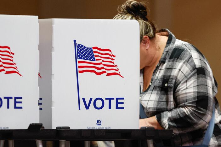 A woman votes at a polling location at The Chapel, an Evangelical church in St. Joseph, Mich., on Election Day, Nov. 5, 2024.