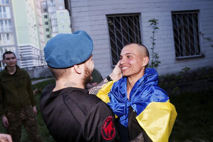 A Ukrainian soldier hugs his comrade after returning from captivity in a POW exchange in Ukraine, on Saturday.