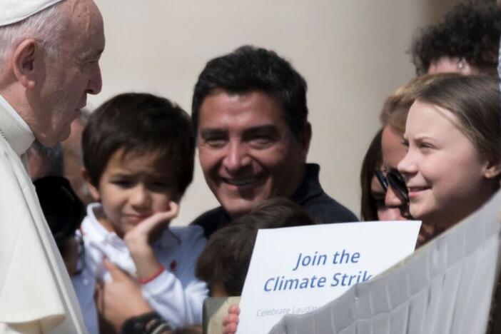 Pope Francis greets Swedish teenage environmental activist Greta Thunberg, right, during his weekly general audience in St. Peter's Square, at the Vatican, Wednesday, April 17, 2019.