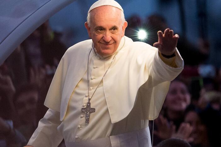 Pope Francis waves to thousands of followers as he arrives at the Manila Cathedral on Jan. 16, 2015, in Manila, Philippines.
