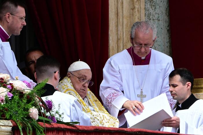 Pope Francis addresses the crowd from the main balcony of St. Peter's Basilica on Sunday.