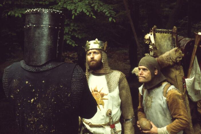 King Arthur (Graham Chapman) and his servant Patsy (Terry Gilliam) encounter The Black Knight (John Cleese)