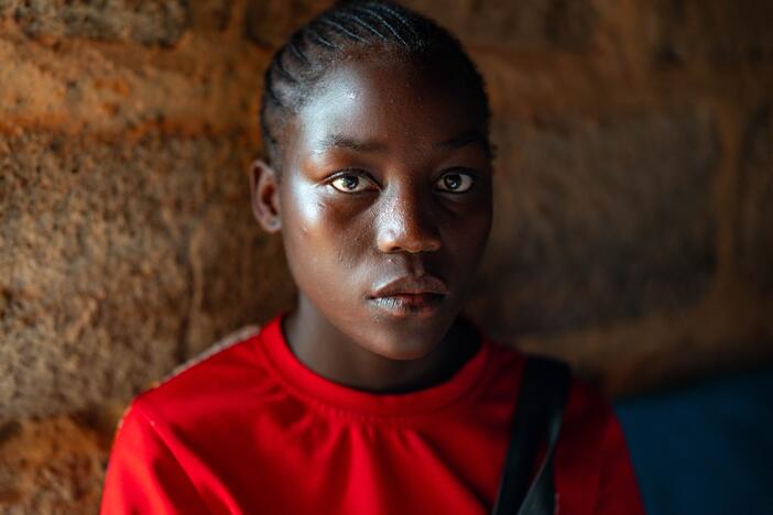 Catherine Mwaloe, 16, who contracted HIV from her mother at birth, has one month's supply of HIV medicine left. She worries that government clinics will charge money for the medications, which were previously free.