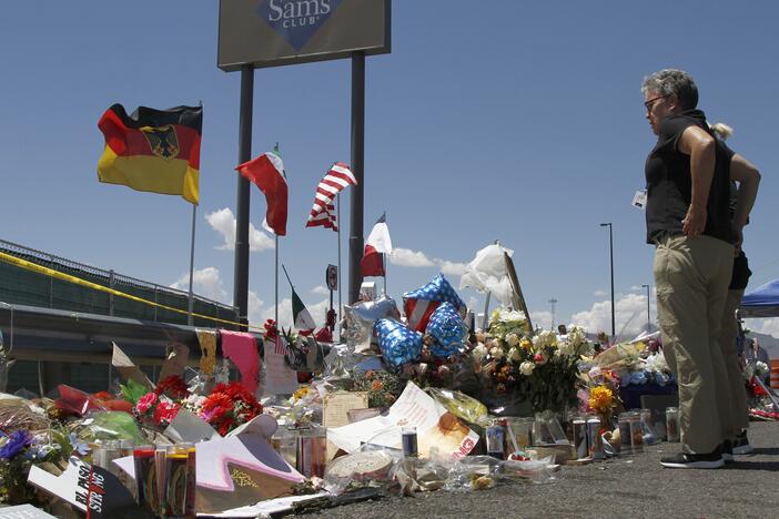 In this Aug. 12, 2019, photo, mourners visit the makeshift memorial near the Walmart in El Paso, Texas.