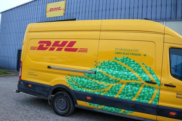 A DHL delivery vehicle is seen in front of a warehouse in Valence, France, in December 2024. The global shipping company announced it would temporarily stop shipping packages valued over $800 to U.S. consumers.