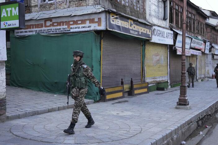 An Indian security officer patrols a shopping area in Pahalgam a day after militants indiscriminately opened fire on tourists near the town, Indian controlled Kashmir on Wednesday.