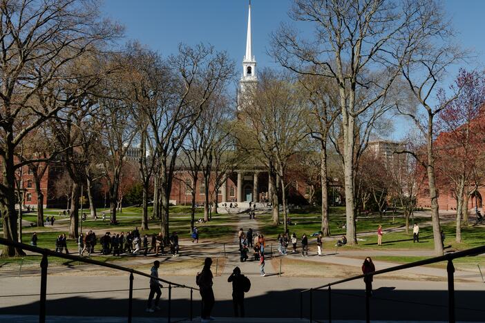 People cross Harvard Yard at Harvard University on April 17, in Cambridge, Mass.