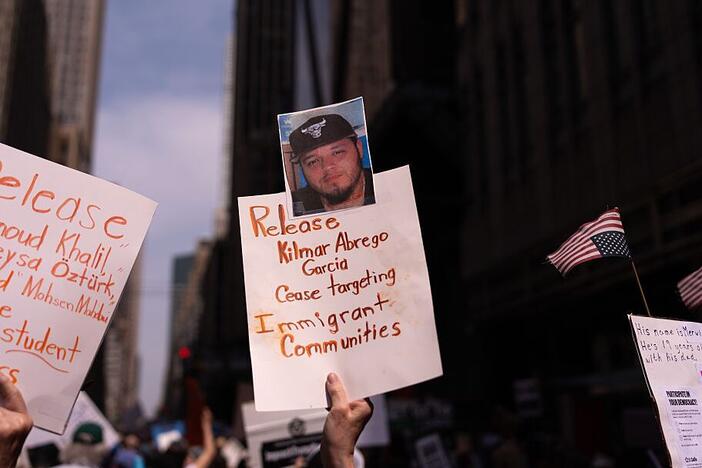 A person holds a sign with a photo of Kilmar Abrego Garcia at a protest in New York City.