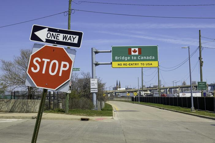 Signs notify drivers at the U.S.-Canada Ambassador Bridge border crossing in Detroit, Michigan.