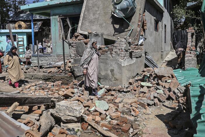 Soldiers in Indian-administered Kashmir blew up the family homes of two men suspected of carrying out Tuesday's deadly attack on tourists in Pahalgam. People walk through the debris of a demolished house related to the family of one of the suspects in southern Kashmir on Friday.