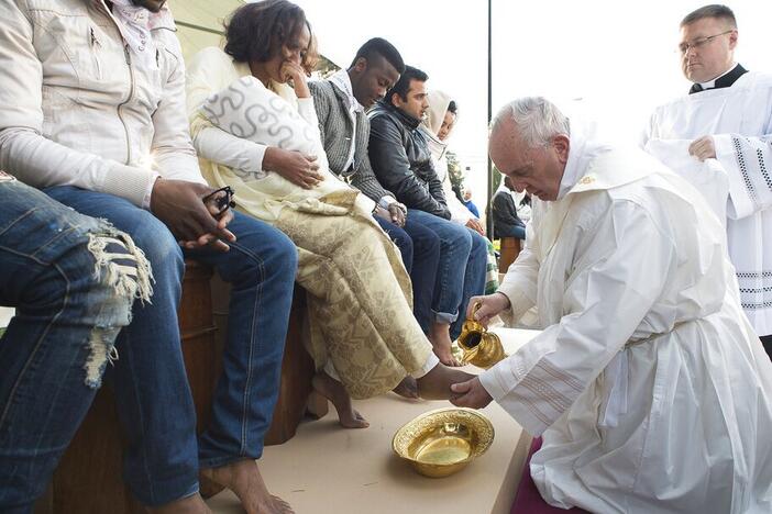 Pope Francis washes the feet of migrants at a refugee center near Rome in March 2016.