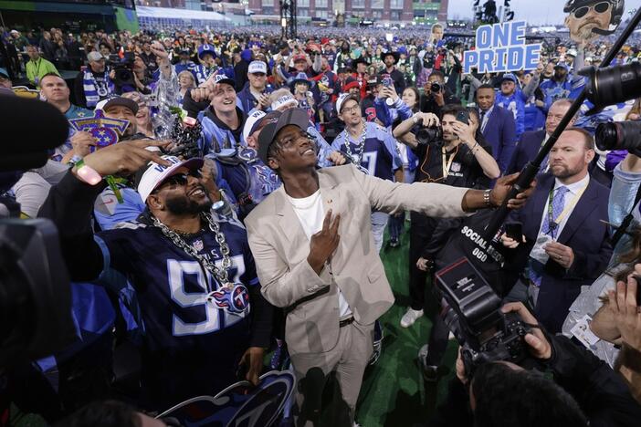 Miami quarterback Cam Ward takes a selfie with fans Thursday after being chosen by the Tennessee Titans with the first overall pick during the first round of the NFL football draft in Green Bay, Wis.