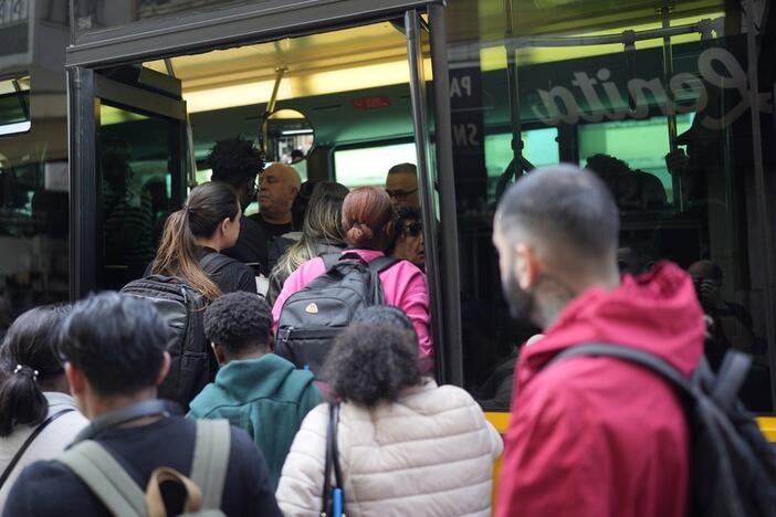 People try to board a crowded bus Monday after the subway stopped running during a power outage in Lisbon, Portugal. (AP Photo/Armando Franca)