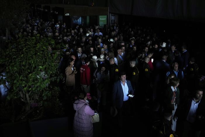 Spectators roam inside the Madrid Open tennis tournament venue during a general blackout in Madrid on April 28.
