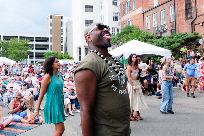 Attendees watch and dance as New Dangerfield performs during the Biscuit & Banjos festival in Durham, N.C., on April 26.