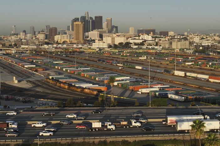 Traffic flows on Interstate 5 past shipping containers near downtown Los Angeles, Tuesday, April 8, 2025.