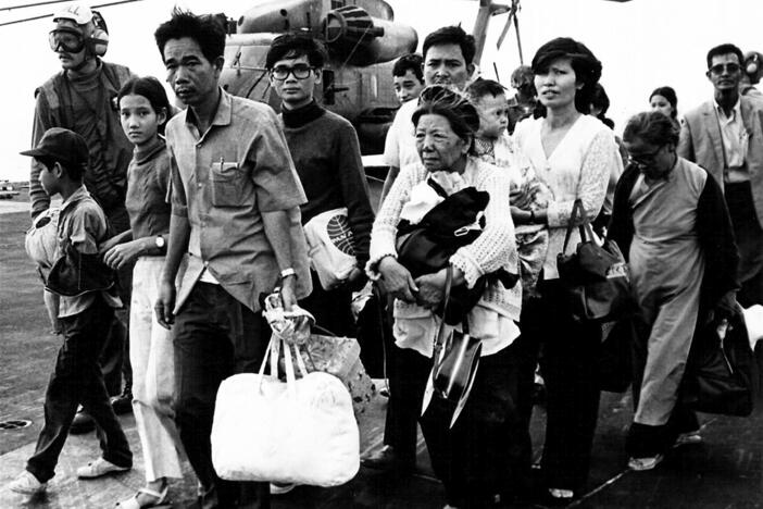 Vietnamese refugees evacuated by helicopter arrive on board the USS Midway ahead of the fall of Saigon on April 29, 1975.