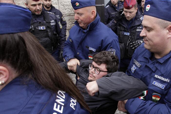 Hungarian police remove a protester blocking the entrance of the Parliament building in Budapest on April 14, as Hungarian lawmakers were expected to approve constitutional changes further clamping down on rights for certain groups, part of Prime Minister Viktor Orbán's "Easter cleanup" against his domestic opponents.