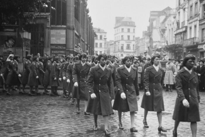 Military personnel of the 6888th Central Postal Directory Battalion take part in a parade in honor of Joan d'Arc in Rouen, France, 1945.