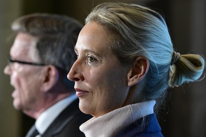 Alternative for Germany (AfD) MP Gerold Otten speaks to the media as co-leader of the far-right party Alice Weidel stands next to him on March 24, 2025, at the Bundestag (lower house of parliament) in Berlin.